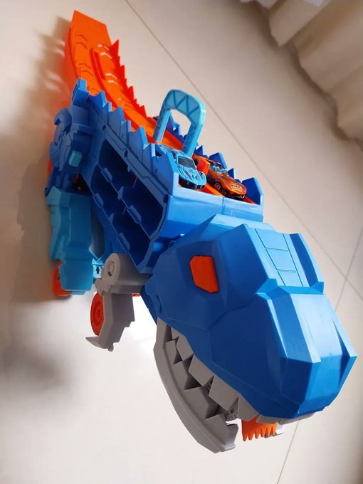 Caminhão Dinossauro Pista Com Carrinhos Maleta Transporte Cor Azul